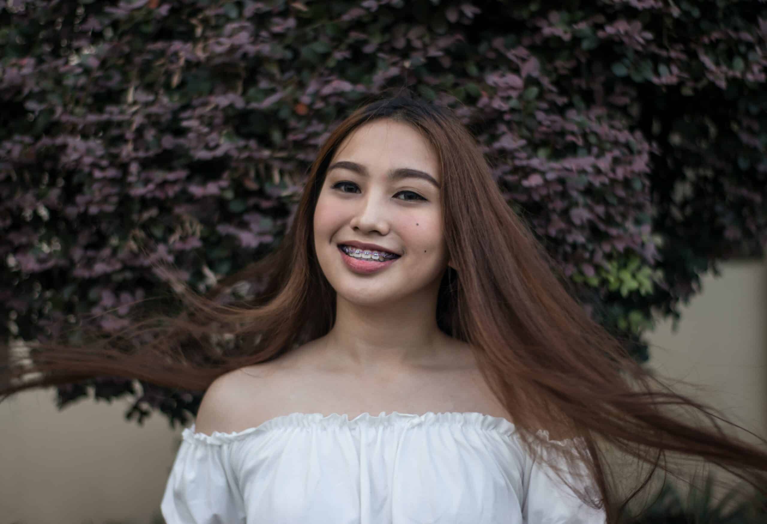 Helpful Fowler Orthodontics Tips & Info 146 Woman with long hair outdoors.