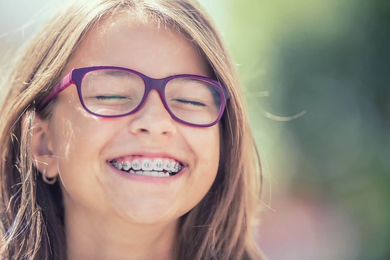 Helpful Fowler Orthodontics Tips & Info 136 Young girl with braces and glasses smiling